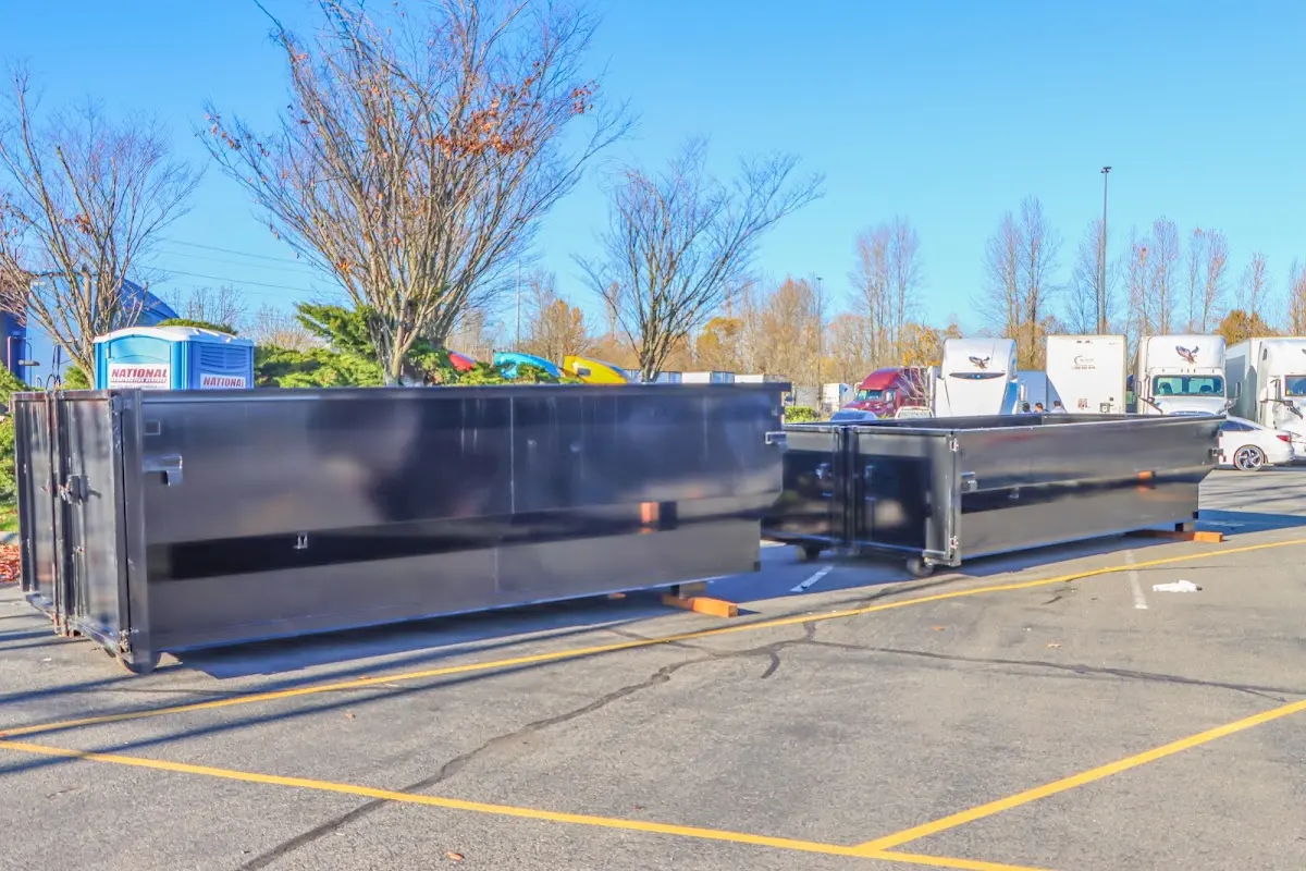 Professional dumpster rental service with roll-off container on residential driveway in Greenwich